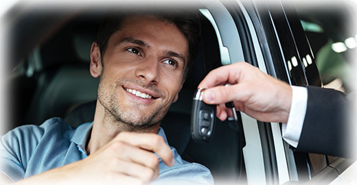 Man being handed car keys through a window